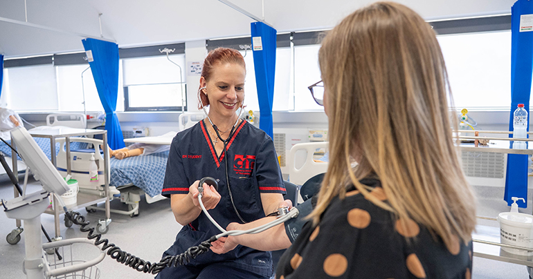 Caitlin doing a blood pressure test